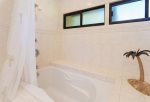 The large soaking tub is the perfect place to unwind after a long ay at the beach